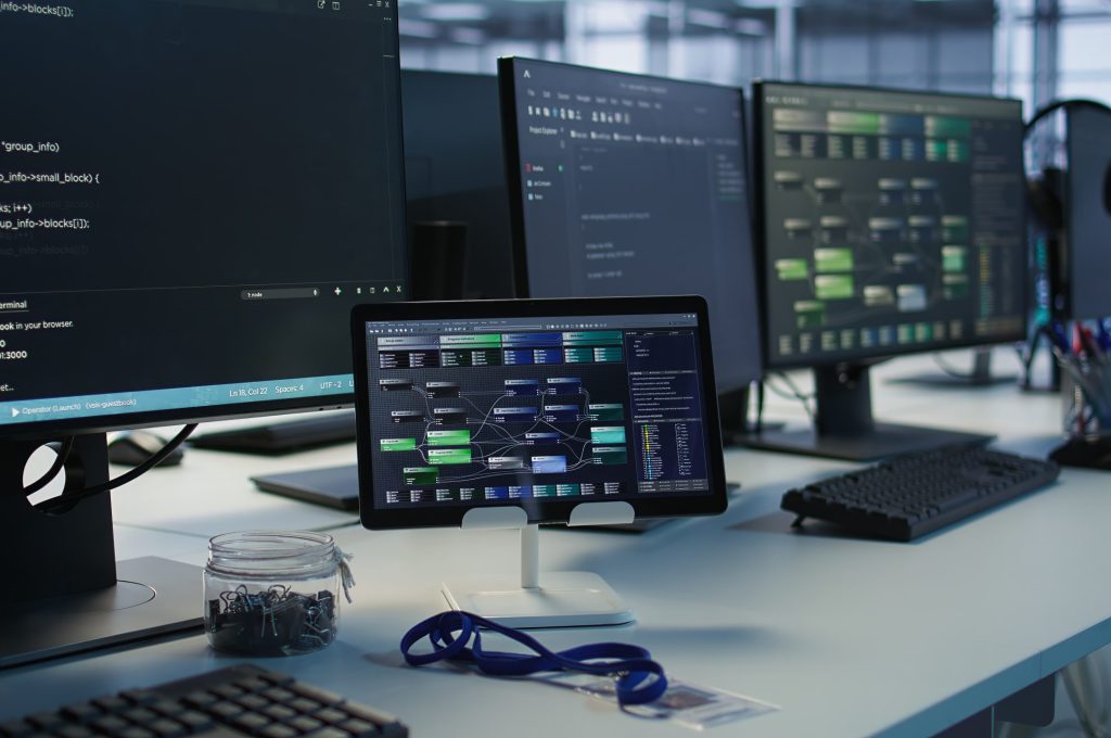 Close up of headphones left by worker on server room PCs used by employees working to ensure minimal downtime. Equipment in data center workplace used for monitoring performance